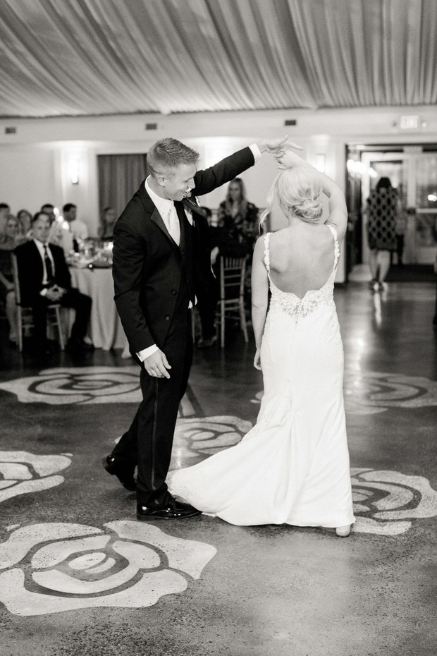Groom dances with bride at wedding reception, elegant and joyful