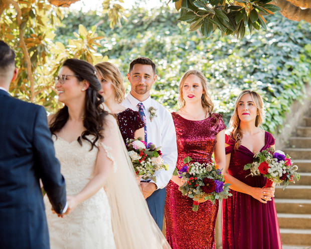 Smiling bride exchanging vows at a beautiful outdoor wedding ceremony