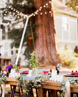Wedding table decor with garland, flowers, Mr & Mrs sign