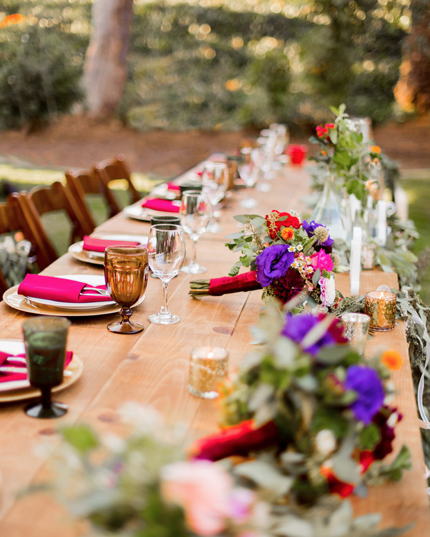Elegant outdoor wedding table setting with floral centerpieces