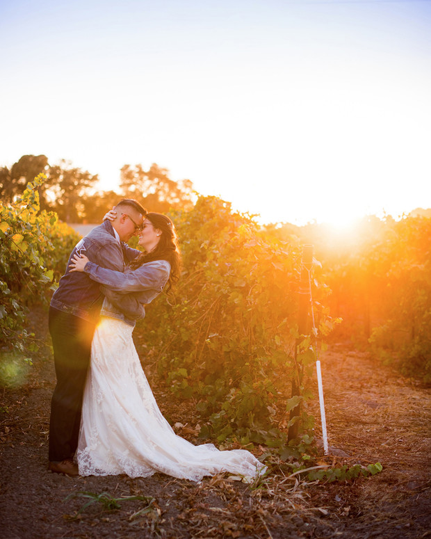 Couple embracing in a vineyard at sunset, golden hour, love