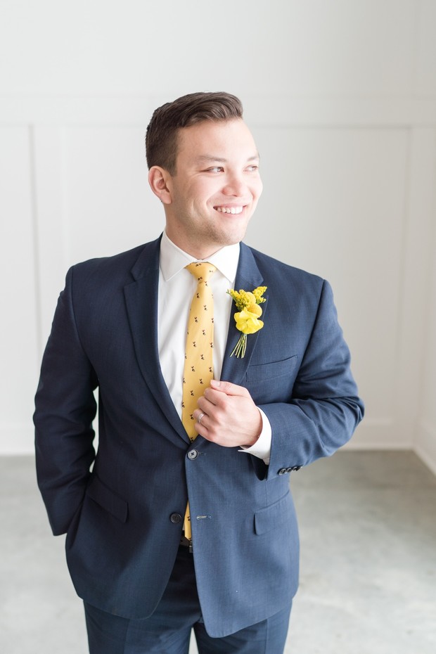 groom in navy and yellow