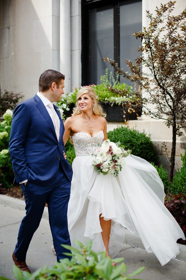 Smiling bride and groom walking after the wedding ceremony