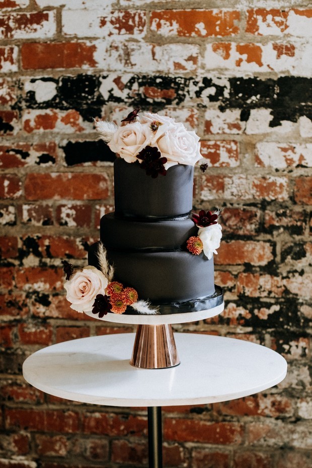 all black and flower topped cake