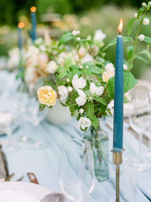 Elegant wedding table setting with flowers and lit candle