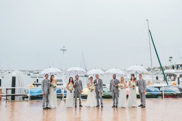 wedding party in the rain with umbrellas