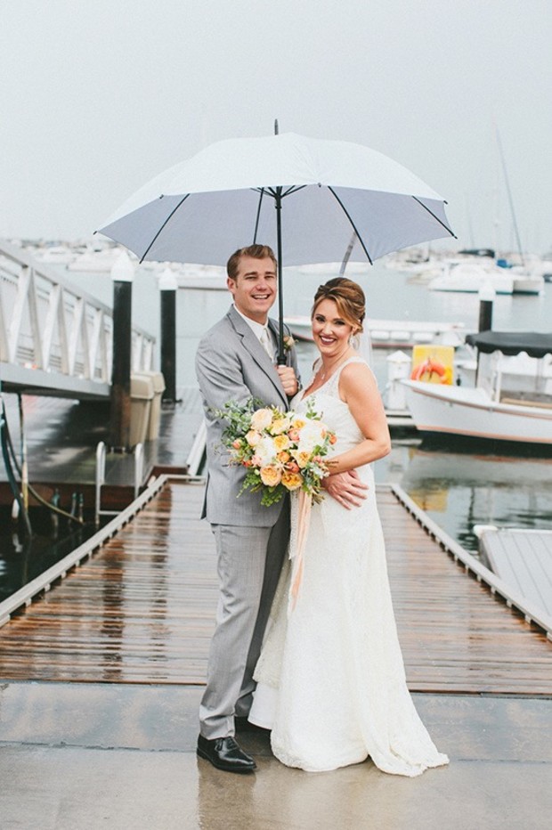 wedding couple in the rain with an umbrella