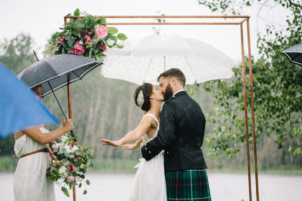 cute wedding kiss in the rain
