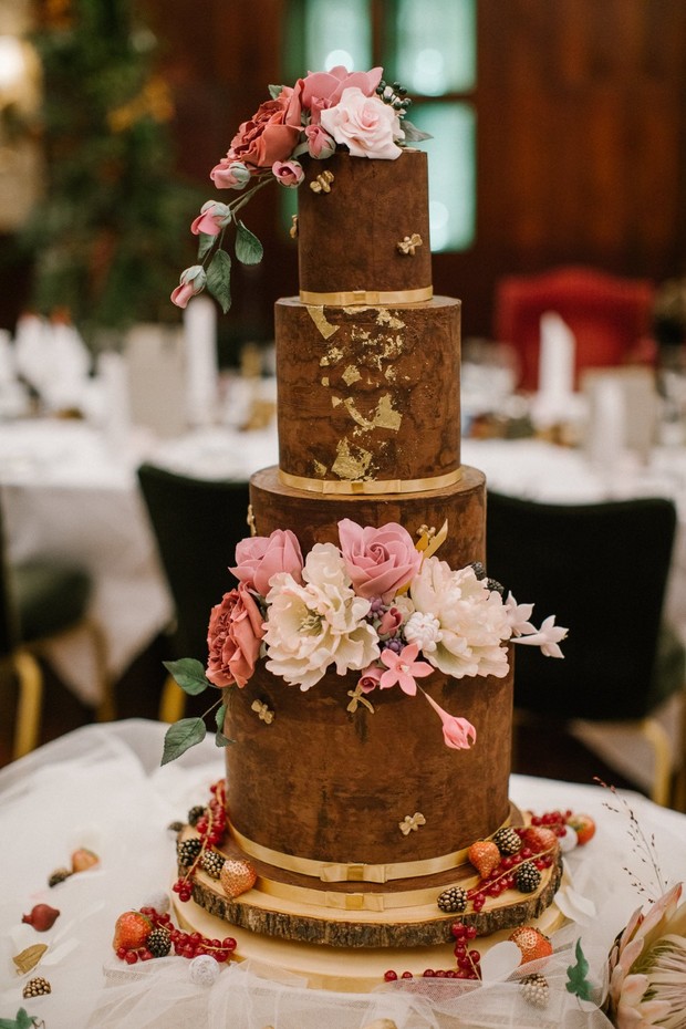 floral topped cake in brown and gold
