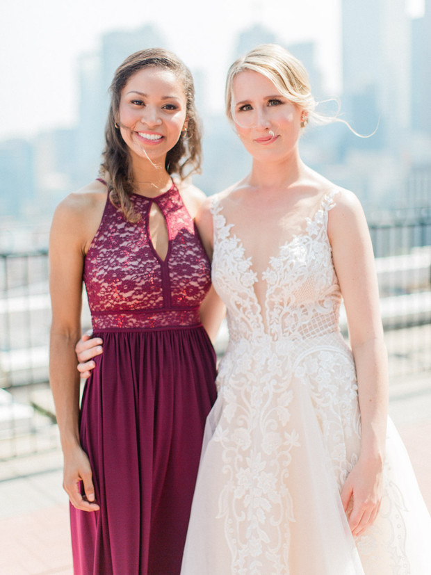 Two smiling women in elegant dresses posing together