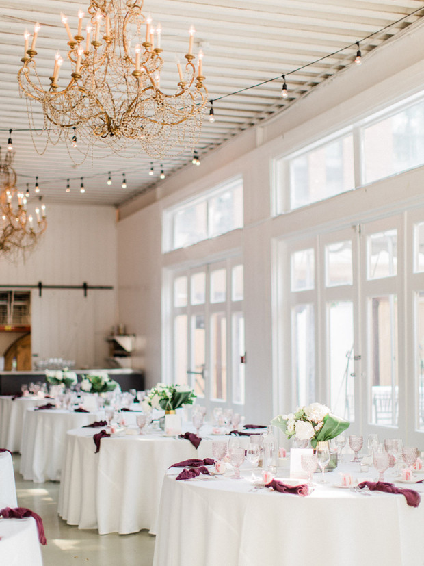 Elegant wedding reception hall with tables and chandeliers