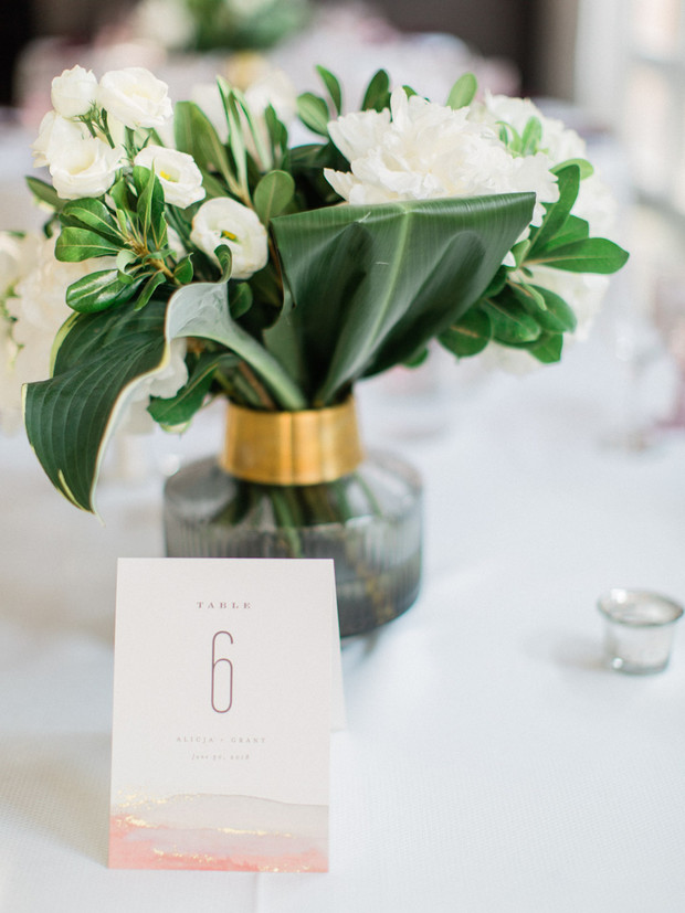 Elegant wedding table setting with floral arrangement and table number