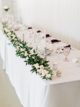 Elegant wedding table setting with floral garland centerpiece