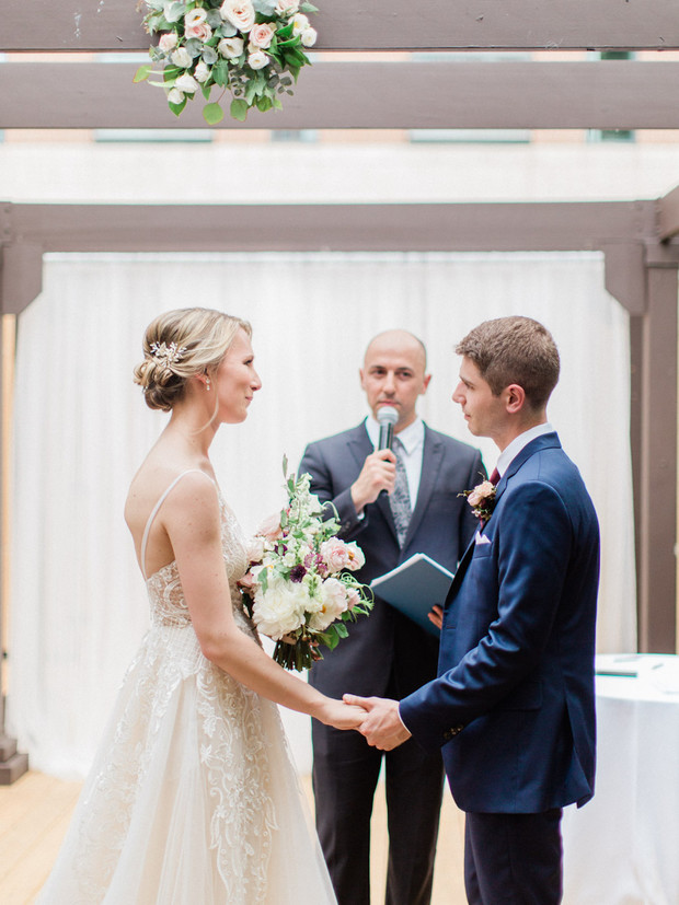 A beautiful wedding ceremony with couple holding hands during vows