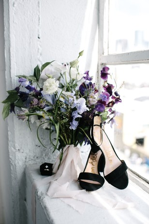 white and purple wedding bouquet with black wedding heels