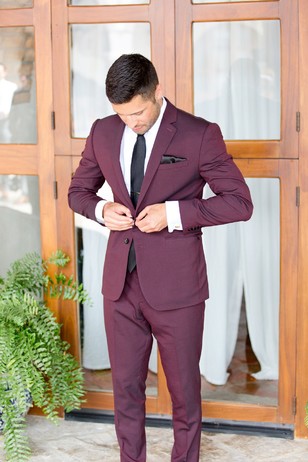 groom in burgundy suit