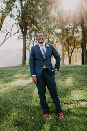 groom in floral tie and navy suit
