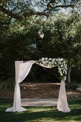 asymmetrical wedding arch backdrop