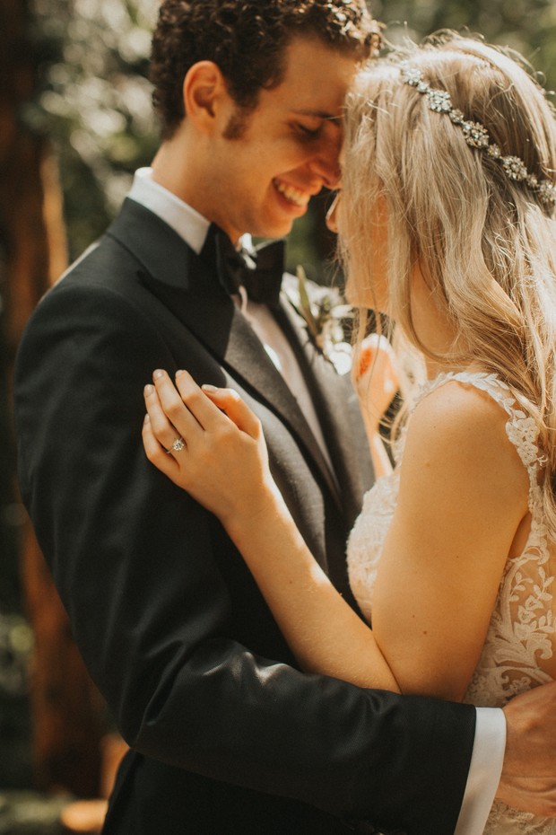 Happy couple embracing at their wedding smiling with love