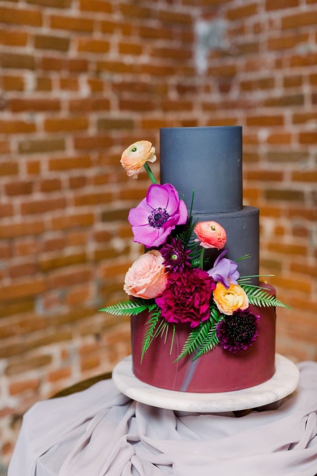 charcoal grey and burgundy wedding cake with floral accents
