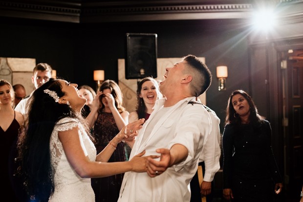 Happy couple laughing and celebrating at their wedding reception