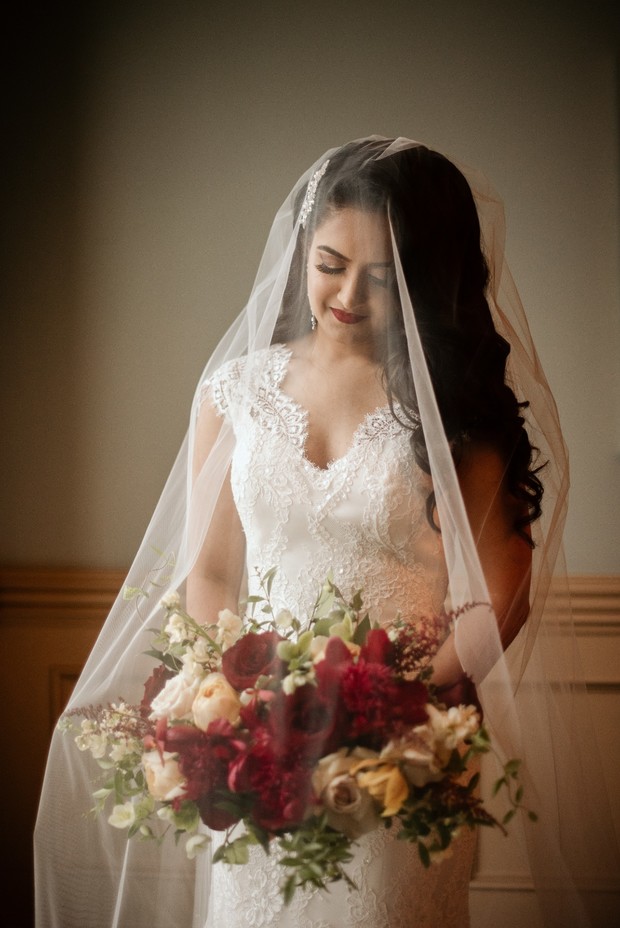 Beautiful bride with floral bouquet on her wedding day