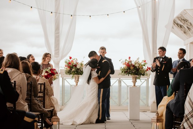 Bride and groom embrace at wedding ceremony  Guests celebrate