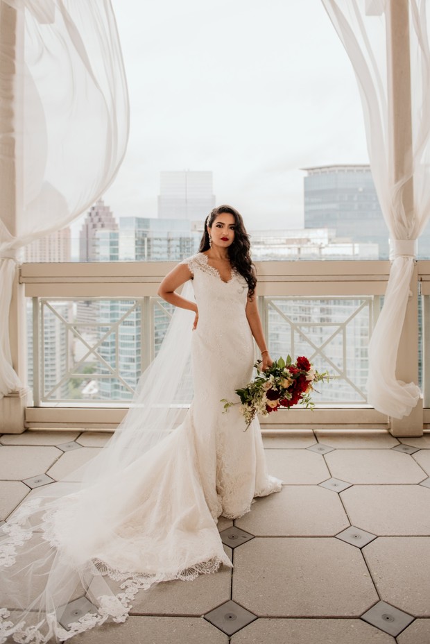 Elegant bride in lace wedding dress, holding bouquet