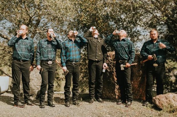 groomsmen in flannel with beers and axes