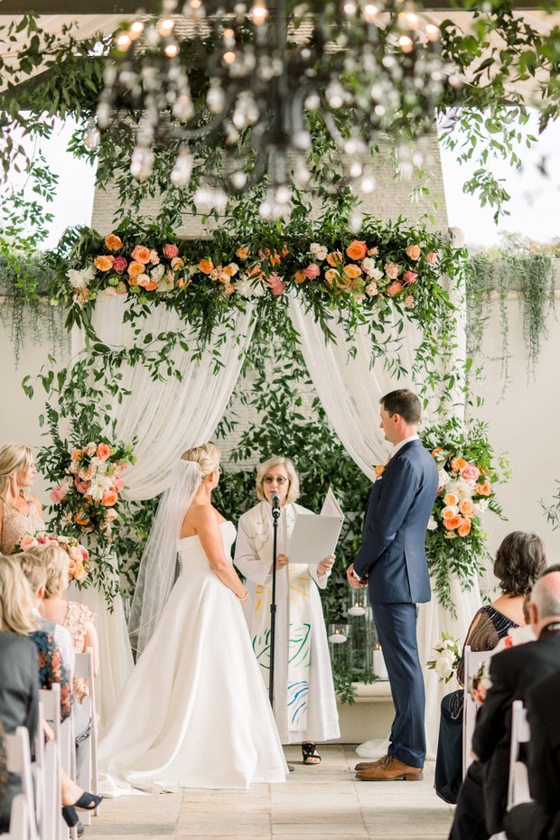 flower draped wedding ceremony backdrop