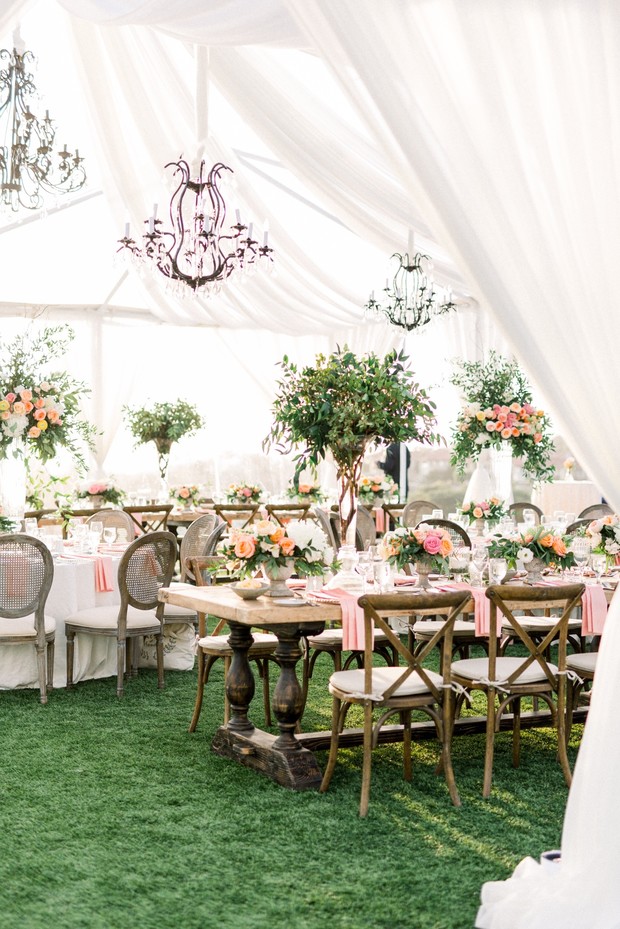 blush and coral wedding reception decor under a tent
