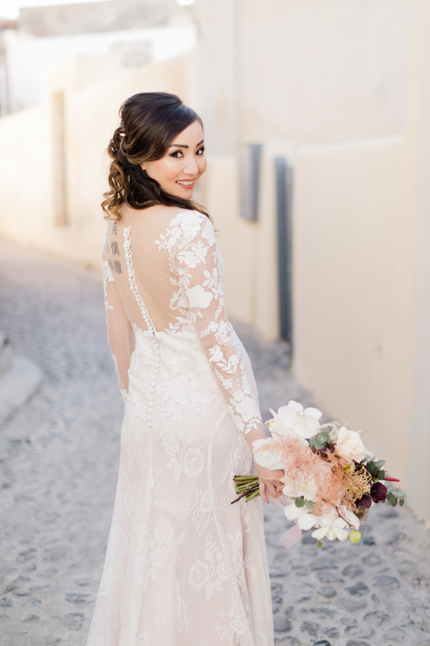 bride in sheer sleeved wedding dress