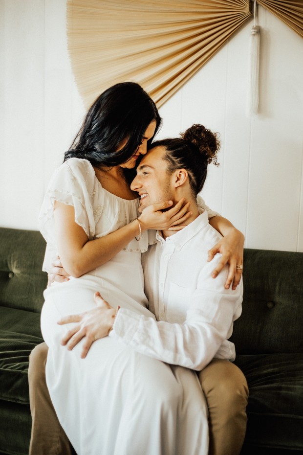 Couple embracing on a sofa with affection indoors
