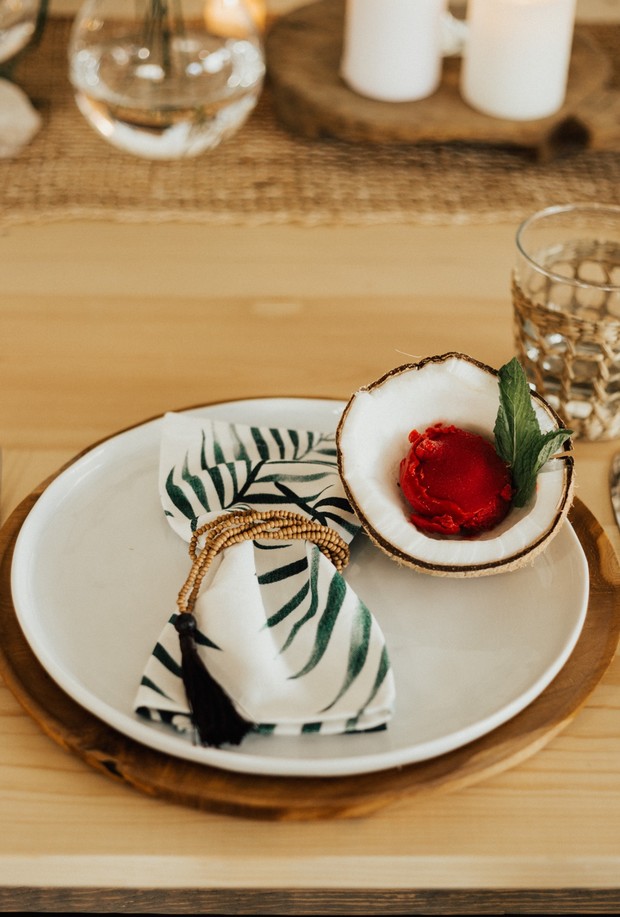 Coconut dessert and leaf patterned napkin on a dining table