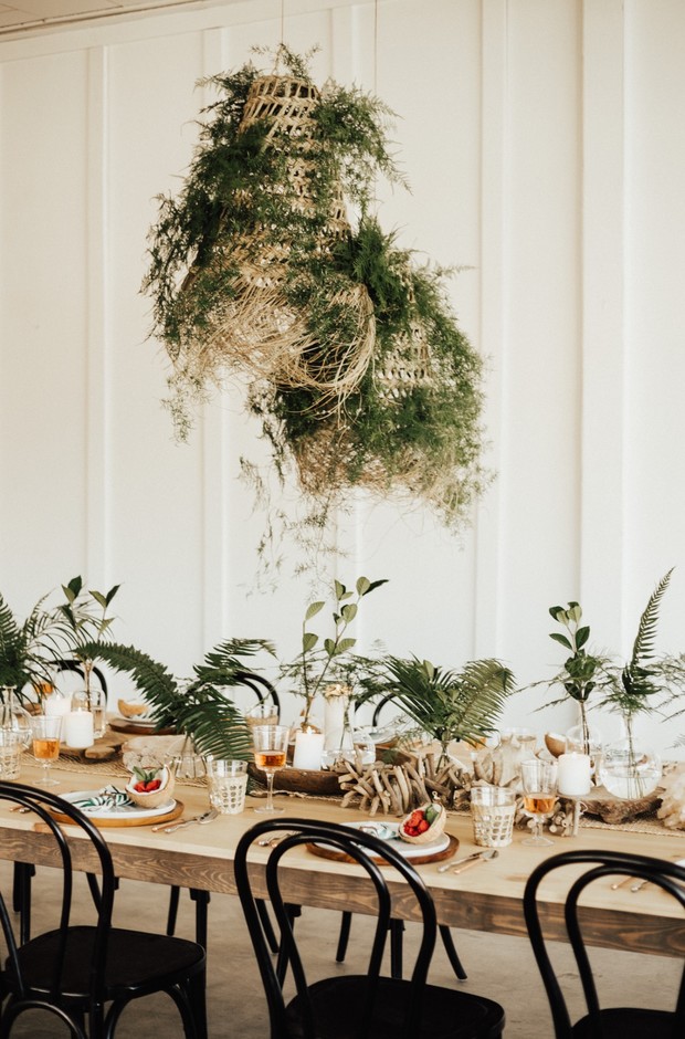 Elegant wedding table with green botanical centerpiece