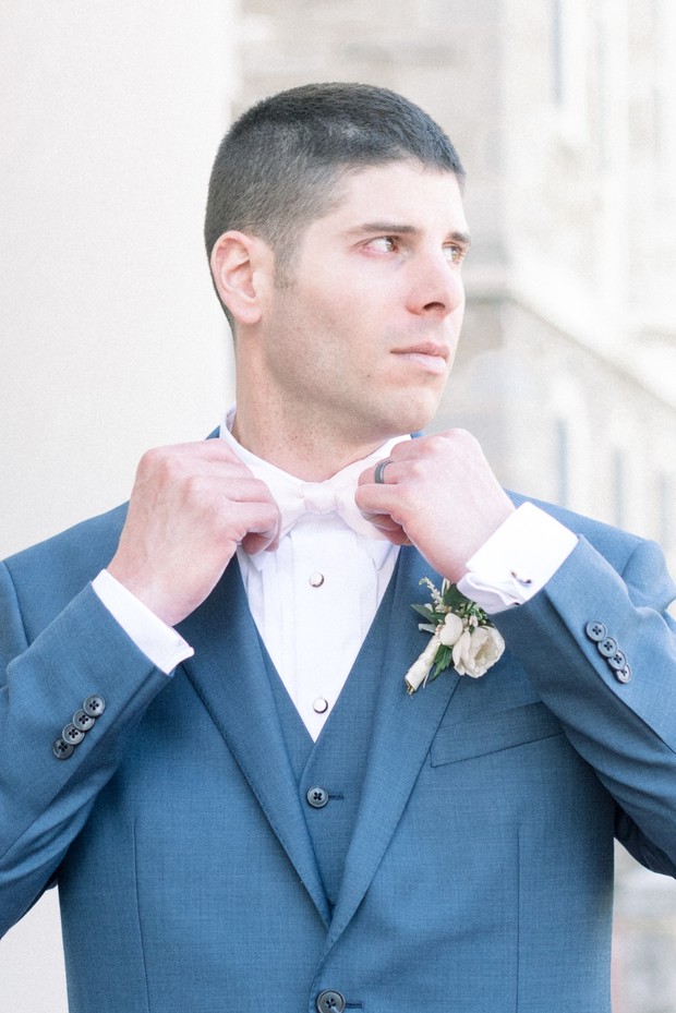 groom in blue suit and pink bow tie