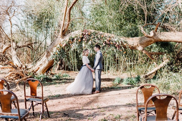 outdoor wedding ceremony with floral backdrop