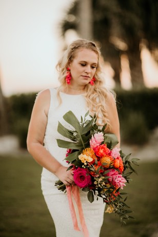 bride with tropical sunset inspired bouquet