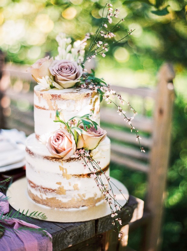 naked wedding cake with gold accents