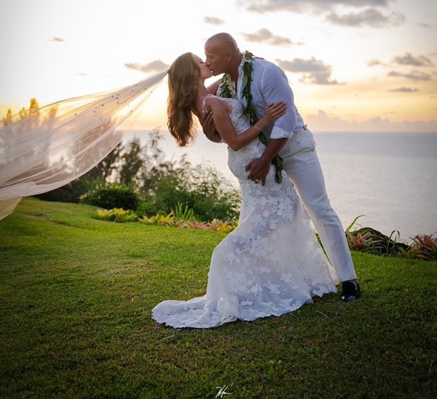 The Rock and his bride Lauren Hashian kissing at sunset