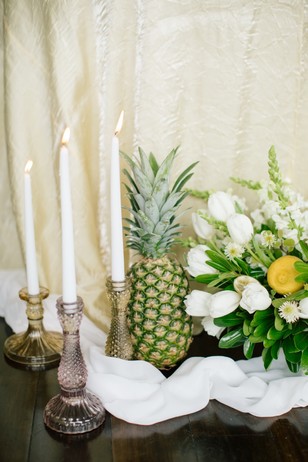 candles flowers and fruit wedding decor