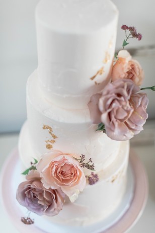 blush and gold flower topped wedding cake