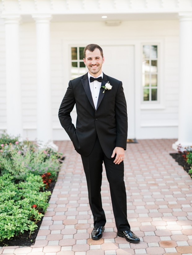 groom in classic tuxedo suit