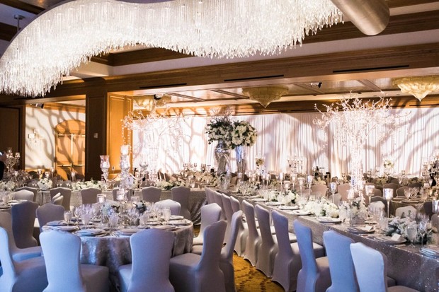 Elegant wedding reception hall with chandeliers and flowers