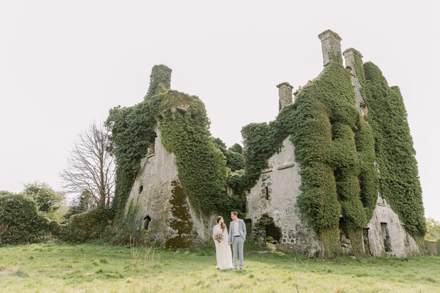 Couple at ivy covered castle wedding ruin Ireland