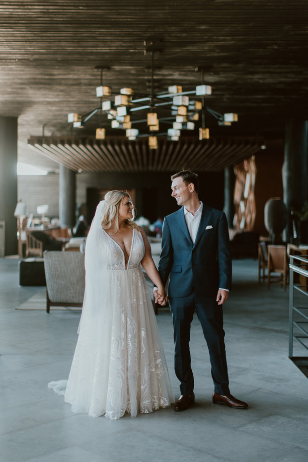 Bride and groom holding hands at their luxury wedding
