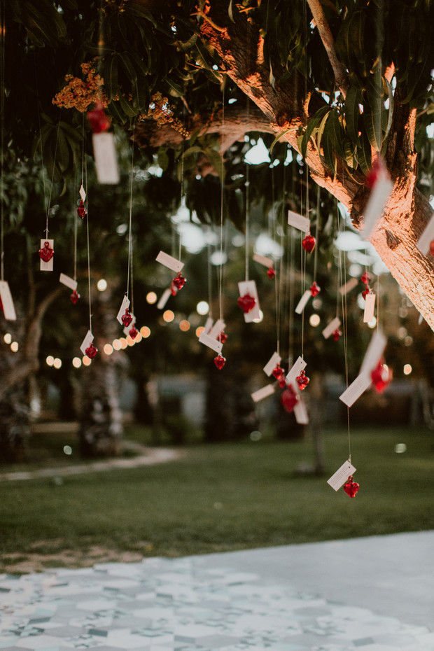 Romantic outdoor tree decoration with hanging hearts and notes