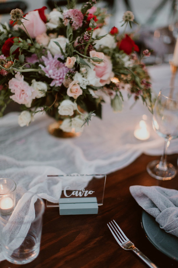 Elegant table setting with floral arrangement and Cairo name card