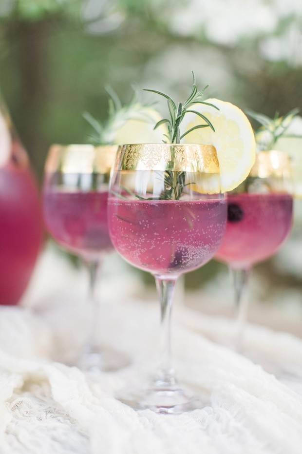 Pink cocktails with lemon and rosemary garnish