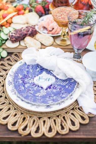 Elegant table setting with floral plate and appetizer buffet